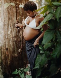 A pregnant woman in the woods